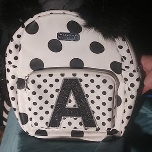 Justice cream and black little backpack purse with